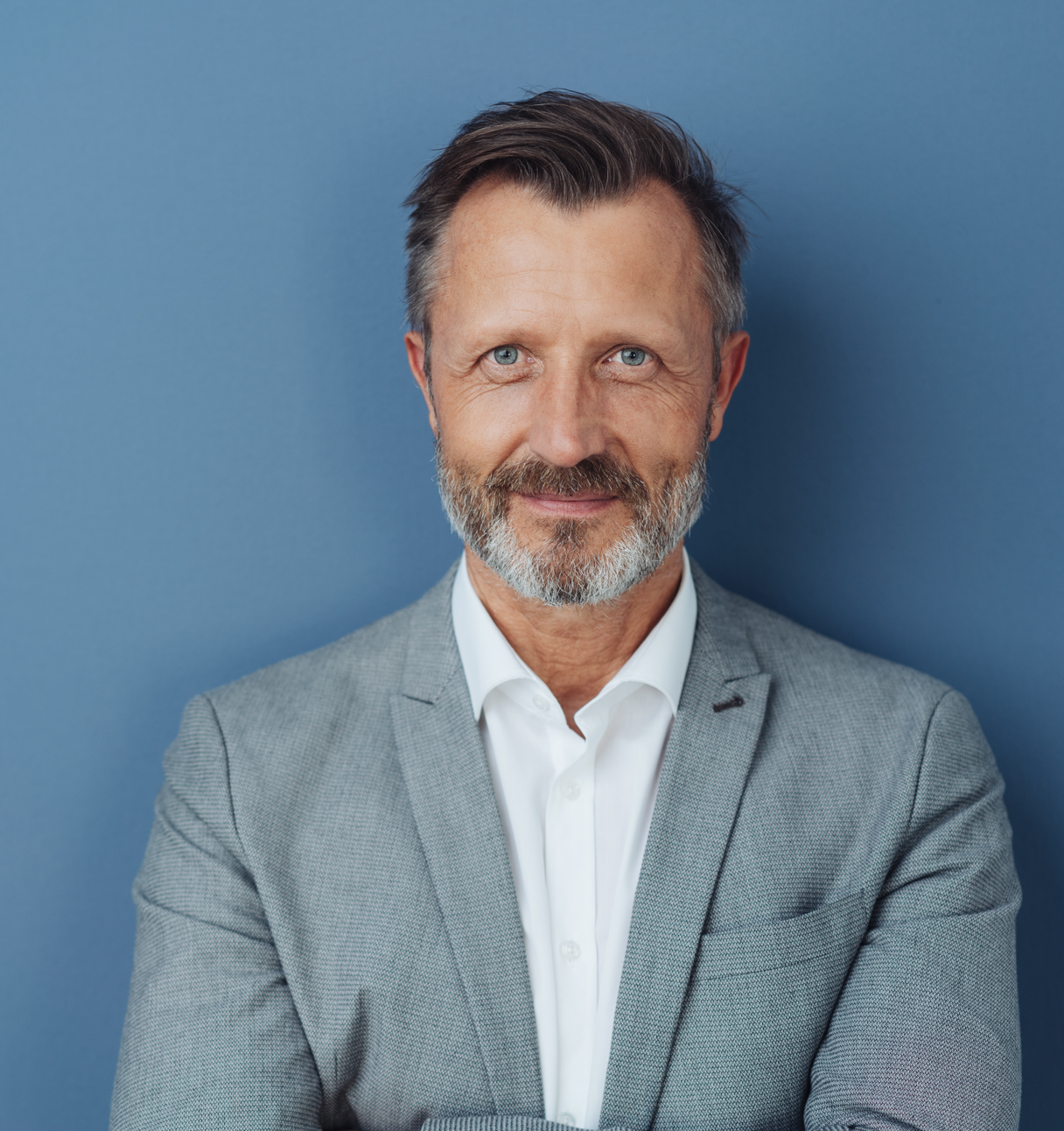 Middle aged man wearing a grey suit (top block)