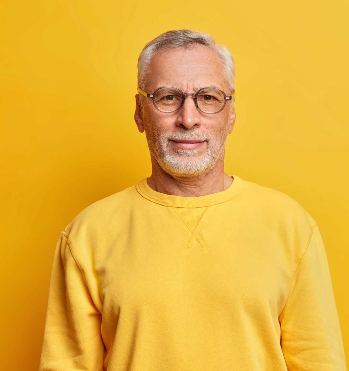Senior man wearing yellow sweater (top block)