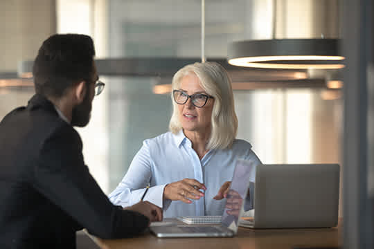 Man and woman in conversation around a table