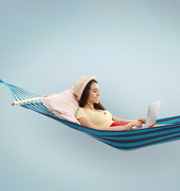 Woman lying down in a hamac on a terrace