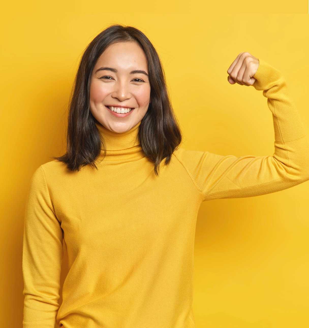 Young woman doing a power pose (top block)