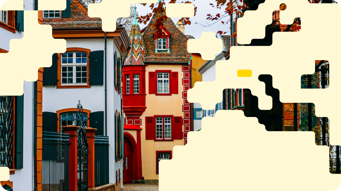 Colorful European buildings with red and white facades shown as a partially completed jigsaw puzzle on cream background.