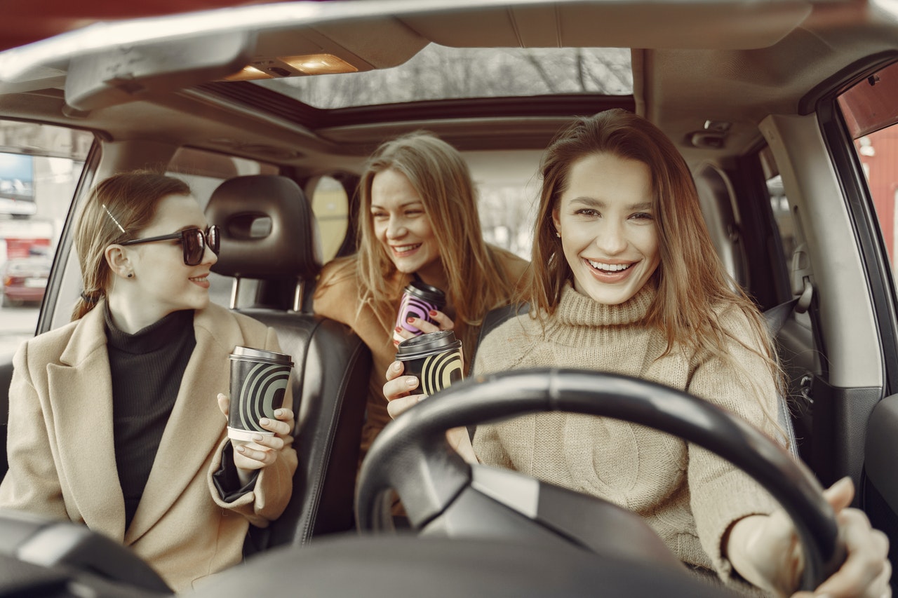 three women driving in a car