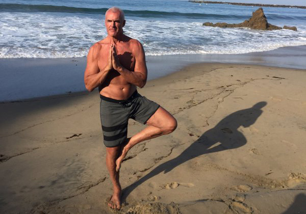 Steve Wright yoga pose on beach