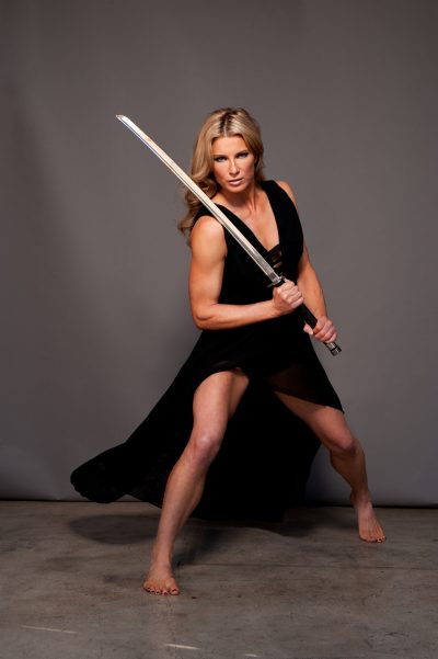 Heidi Moneymaker with a sword in a dress