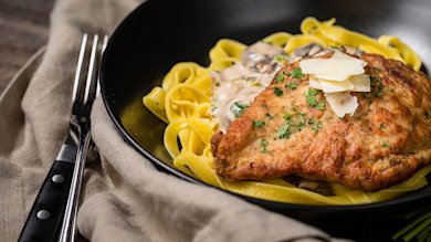 Breaded pheasant cutlet on tagliatelle with mushroom Marsala cream and shaved Parmesan