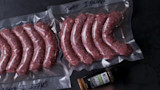 Vacuum-sealed raw sausages in bags labeled "SWEET ITALIAN" with jar labeled "WESTON SAUSAGE SEASONING"