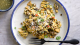 Venison migas: scrambled eggs with tortilla chips, cotija cheese and cilantro; green salsa and fork