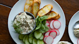 Creamy fish dip with dill, toasted crostini, cucumber and radish slices