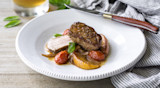 Seared pork medallion with stone‑fruit slices, cherry tomatoes and pan sauce on white plate