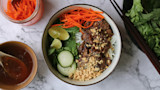Lemongrass venison vermicelli bowl with shredded carrots, cucumber, lime wedges, mint, crushed peanuts