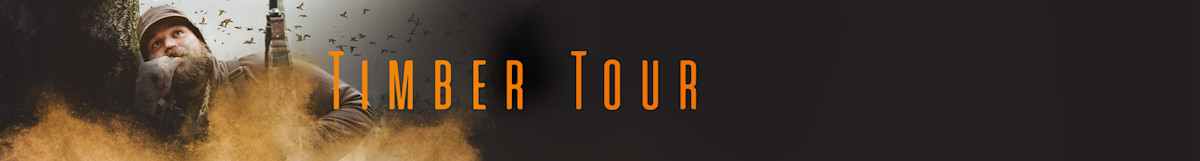 Bearded hunter crouched behind a tree in camouflage with "TIMBER TOUR" text overlay
