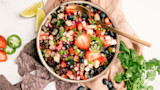 Bowl of berry salsa with strawberries blueberries blackberries jalapeno lime and blue corn chips