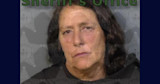 Middle-aged woman with dark hair and neutral expression; "Sheriff's Office" text overlay