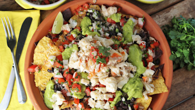 Lobster nachos with tortilla chips, black beans, pico de gallo, avocado, cilantro and lime