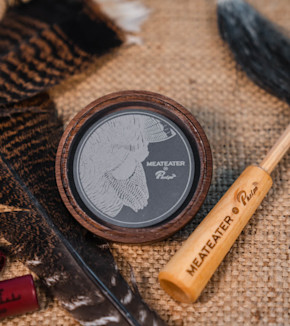 Round turkey pot call with slate insert engraved MEATEATER Phelps and wooden striker labeled MEATEATER Phelps