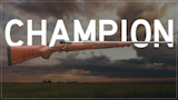 Bolt-action hunting rifle with wood stock over large CHAMPION text