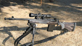 Bolt-action hunting rifle on bipod with scope and detachable box magazine