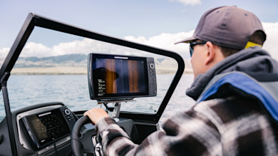 Humminbird side-imaging sonar display with man steering a boat