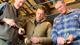 Three men testing handheld knife sharpeners, center wearing First Lite jacket