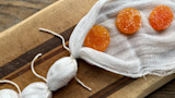 Three salt-cured egg yolks on cheesecloth-lined cutting board