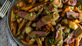 Venison poutine: fries topped with cheese curds, brown gravy, seared venison slices and sliced scallions