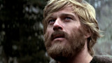 Close-up of bearded blond man looking upward in a misty forest