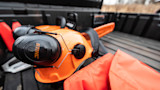 STIHL orange safety helmet with earmuffs, 'STIHL' text on earcup