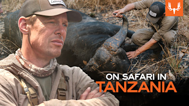 Hunter beside downed buffalo; text overlay: ON SAFARI IN TANZANIA