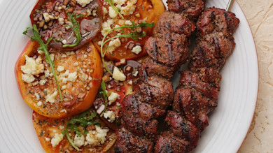 Grilled venison skewers with heirloom tomato, arugula and feta salad