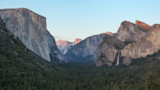 Yosemite Valley panorama with El Capitan left, Half Dome center, waterfall right, dense pine forest