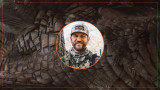 Smiling hunter in camo wearing hat reading 'onX Hunt' in circular portrait over turkey feathers