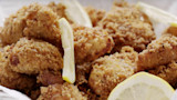 Crispy breaded fried fish bites with lemon wedges