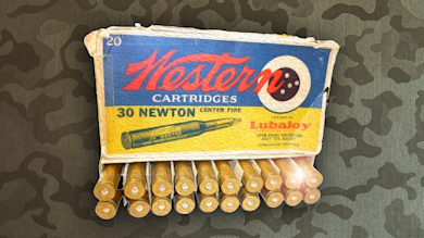 Western Cartridges box reading "30 NEWTON CENTER FIRE" and "Lubaloy", row of brass cartridges