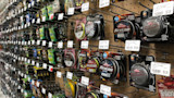 Wall display of packaged fishing line spools, including Berkley FireLine and NanoFil labels