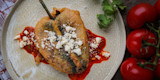 Venison chile relleno with red tomato sauce, crumbled cheese, cilantro and vine tomatoes