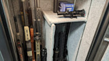 Gun safe interior with rifles, a scope, and a Federal ammo box labeled 'FEDERAL'