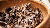 Woven basket of dark, funnel-shaped mushrooms