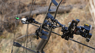 Compound bow riser with TROPHY RIDGE single-pin sight and arrow rest
