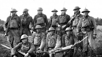 World War I soldiers standing and kneeling, wearing helmets, holding rifles with bayonets and a machine gun