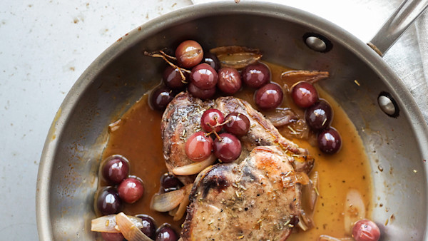 Pan-roasted pheasant with red grapes and shallots in a brown pan sauce