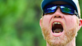 Stonefly on angler's tongue, man in blue cap with mirrored sunglasses