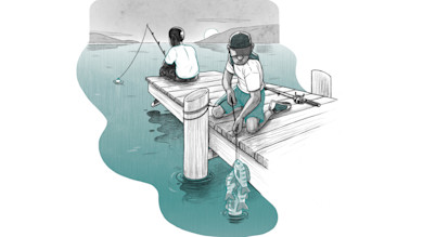 Two people fishing on a dock; kneeling person reels three fish up on a line.