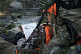 Hunter in camouflage reading a magazine showing the text "The New Yorker" and "The Talk of the Town"