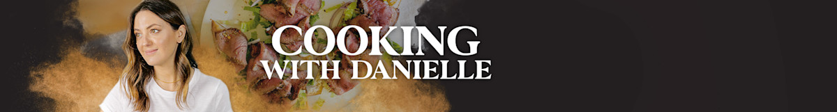 COOKING WITH DANIELLE; woman in white shirt looking right beside plated meat