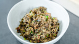 Bowl of duck dirty rice with green onions