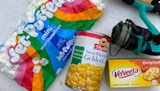 Jet-Puffed mini marshmallows bag, ShopRite Golden Corn can, Velveeta box, teal fishing reel