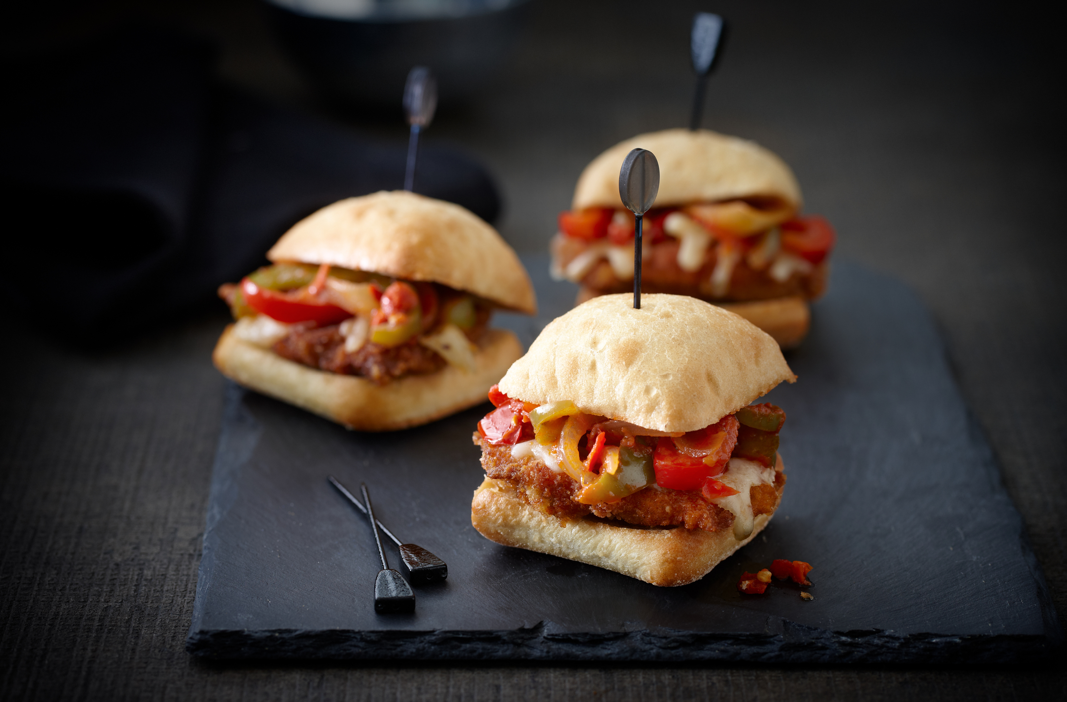 3 breaded veal sliders on ciabatta buns with tomato sauce, peppers & cheese
