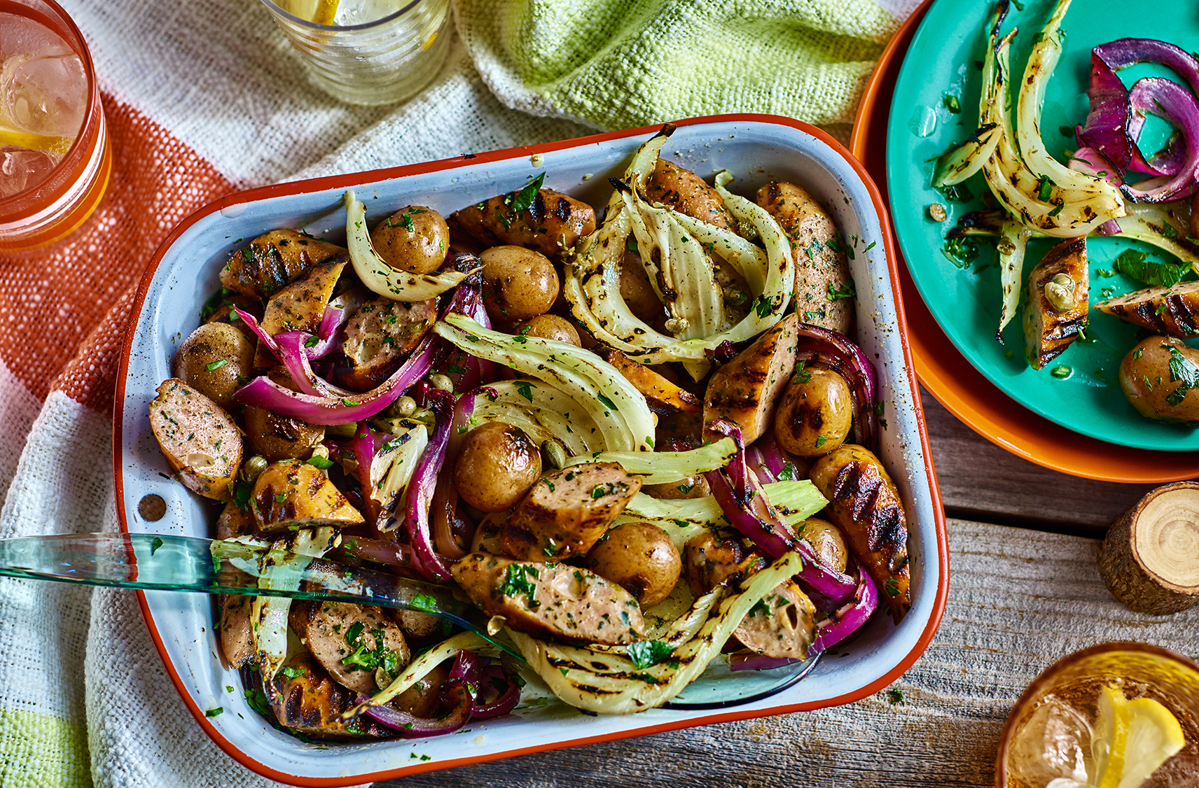 A platter of grilled sausage and potato salad with fennel and onions
