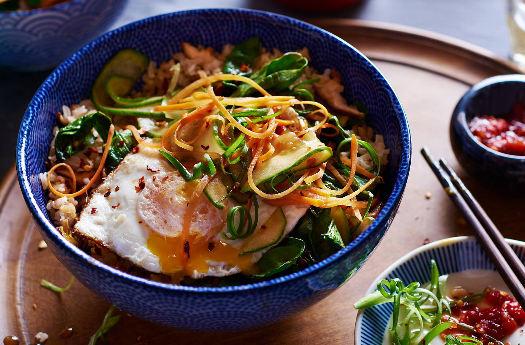 A medley of colour vegetable stands and rice topped with a perfectly runny egg